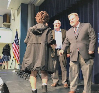 Superintendent shaking hands on stage