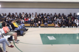 Students in gym for conference